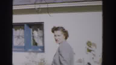 Michigan USA (1958): Three Kids Running In The Backyard While An Older Lady Walks