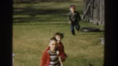 Michigan USA (1958): Boy And Girl Wearing Red Jackets Run Into Blue And Green