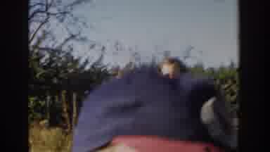 Michigan USA (1958): Two Siblings Playing Outside Of Their House, In The Yard,