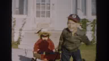 Michigan USA (1958): Children Having Fun Outside While Parents Visit Inside Home
