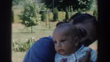 Michigan USA (1958): Woman Showing Her Affection For Her Son Outside Her Home