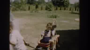 Michigan USA (1958): The Video Shows Four Children Playing Outside, Near A Green