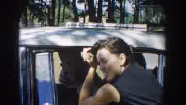 Michigan USA (1958): A Lady At The Car Door Has A Young Boy Try To Mess Up Her