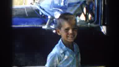 Michigan USA (1958): Young Boy Smiles While Siblings Hold Hands