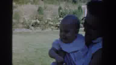 Michigan USA (1958): Woman In Glasses Holding Baby Next To Girl