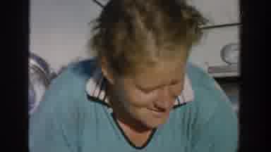 Michigan USA (1958): A Woman Acts Shy And Smiles While Sitting On The Front Bumper