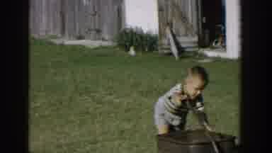 Michigan USA (1958): Too Young Boys Wearing Shorts And T-Shirts Playing On Wagons