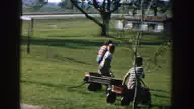 Michigan USA (1958): Sunny Outside Children Playing Radio Flier Toy Rolling Hill