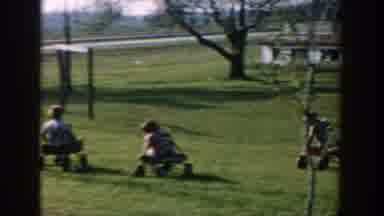 Michigan USA (1958): Young Children Riding In Wagons And Playing With Kittens