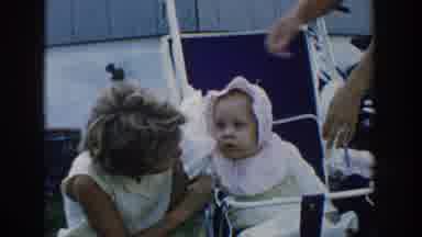 Michigan USA (1958): A Woman And Girl Fuss Over A Baby In A Stroller While