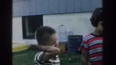 Michigan USA (1958): Three Small Children Looking Around Outside