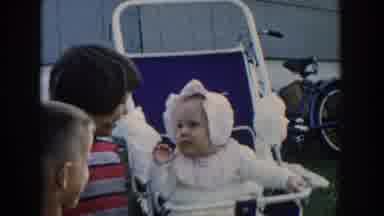 Michigan USA (1958): Children Are Playing With A Baby, Older Child Carries Baby