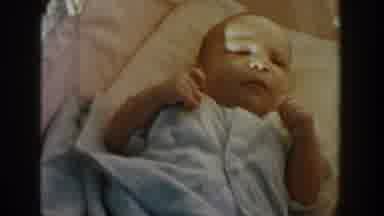 Michigan USA (1958): A Baby Lies Contentedly In A Crib While The Sun Shines