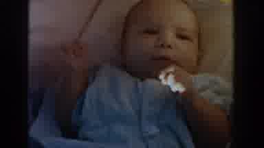 Michigan USA (1958): Baby Laying In Crib Wearing A Jumper Moving His Arms