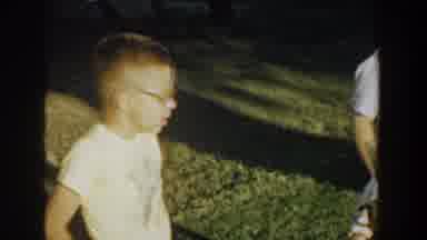Michigan USA (1958): Several Kids Stand On The Grass As They Hold A Kitten