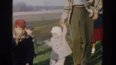 Michigan USA (1958): Mothers With Their Children Are Walking On The Grassland