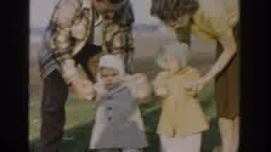 Michigan USA (1958): Two Babies Walking With Their Mother And Father