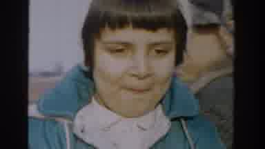 Michigan USA (1958): A Girl In An Aqua Colored Coat Looks At The Camera As A Boy