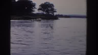 Wisconsin USA (1958): Boy In Blue Swim Trunks Splashing In Water Driving Motor