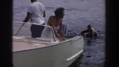 Wisconsin USA (1958): A Man And Woman Are In A Boat As A Boy Walks With A Water