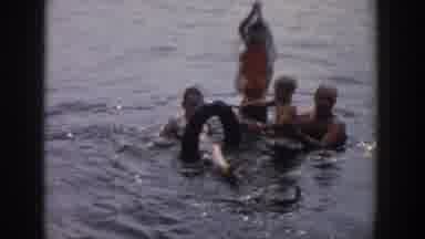 Wisconsin USA (1958): Two Men And Two Kids Are Playing At The Sea