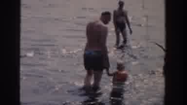 Wisconsin USA (1958): Family Enjoying Holiday In Sea Showing Small Kids Playing In