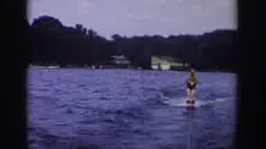 Wisconsin USA (1958): A Man Water Skiing Behind A Boat On The River,