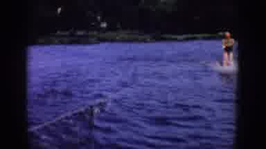Wisconsin USA (1958): A Boy Is Riding In The Middle Of The Sea With Skater