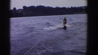 Wisconsin USA (1958): A Water Skier Zig And Zags Over Boat Wake On A Body Of Water