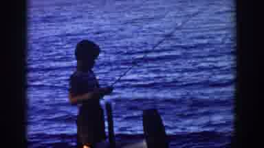 Wisconsin USA (1958): A Child Reels Line While Fishing