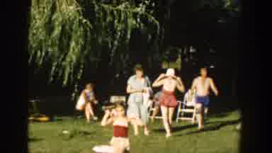 Wisconsin USA (1958): Family Enjoys An Outdoor Park By Willow Tree Wearing