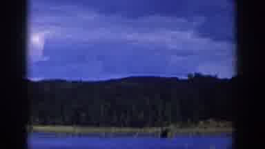 Wisconsin USA (1958): Viewing Lake With Woods Surrounding And Clouds Right Above