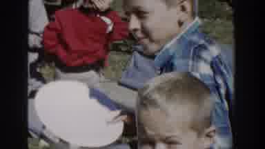 Wisconsin USA (1958): Three Boys Stand In Camera As Another Boy Looks Off Into The