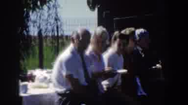 Wisconsin USA (1958): Five People Sitting On Picnic Bench Eating On Sunny Day