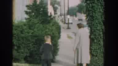 Wisconsin USA (1964): Woman Walking The Sidewalk With Boy For A Cheerful Walk