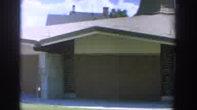 Wisconsin USA (1964): Two Women Walking Towards Modern Brick Building On Sunny Day