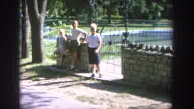 Wisconsin USA (1964): A Man Walking Near A Children's Park And Kids Leaves Some