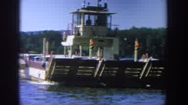 Wisconsin USA (1964): A Man Driving A Barge Down The River On A Beautiful Sunny