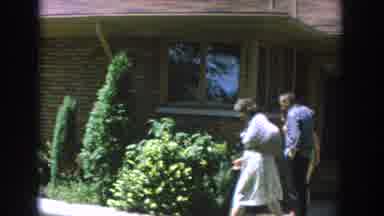 Wisconsin USA (1964): A Woman In Front Of House Is Walking Towards Two Women