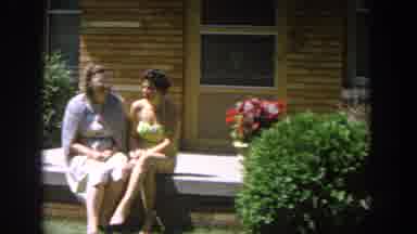 Wisconsin USA (1964): Women Sit Together On Patio In The Sun