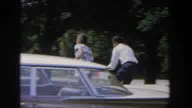 Wisconsin USA (1964): People Riding Bikes, Man Standing In Garden