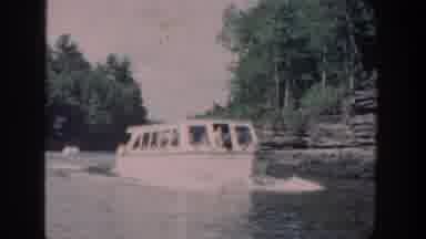 Wisconsin USA (1964): Little Boat With People On A River In The Middle Of A Forest