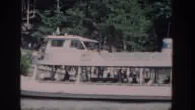 Wisconsin USA (1964): Panning Shot Of A Boat On A River, People Leaving The Boat