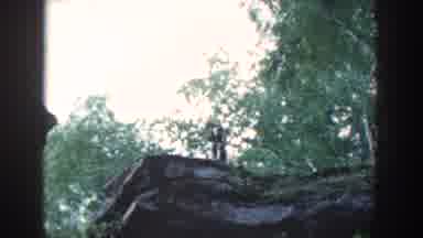Wisconsin USA (1964): Man Watches Dog Jumping From One Rock Ledge To Another