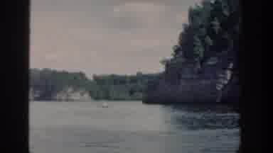 Wisconsin USA (1964): Sea Surrounding Island Covered By Trees And Without Beach