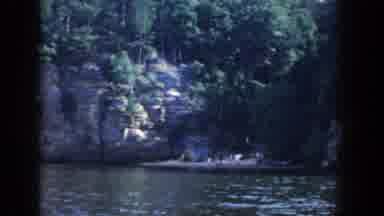 Wisconsin USA-1964: Family Camping On Lakeshore With Rocky Cliffs And Trees