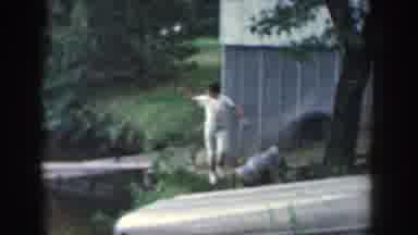 Wisconsin USA (1964): Woman Stepping Off Dock And Walking Along The Shore Near A