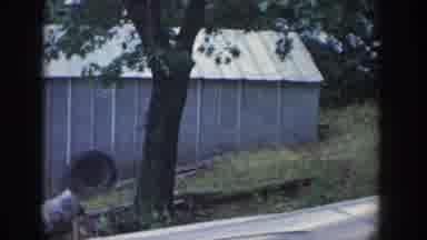 Wisconsin USA (1964): A Boy Walking Up A Hill Outside In The Yard