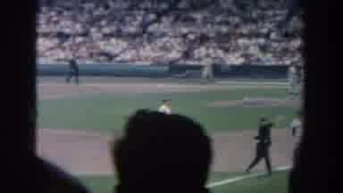 New York USA (1964): Several Fans Watch As Baseball Players Play A Ball Game