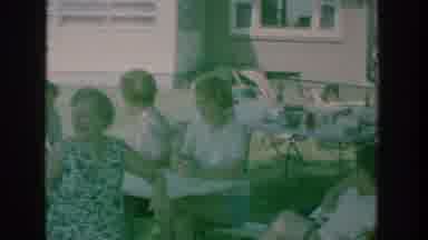 New York USA (1964): Group Of Adults Converse With A Min While Sitting Outside